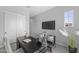 Home office featuring a sliding door closet, wall-mounted TV, modern desk and seating area at 2134 W Rowel Rd, Phoenix, AZ 85085