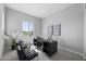 Bright home office features a large window, a modern desk, and comfortable seating at 2134 W Rowel Rd, Phoenix, AZ 85085