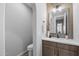 Stylish powder room featuring a modern vanity, decorative mirror, and neutral color palette at 2134 W Rowel Rd, Phoenix, AZ 85085