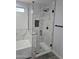 Modern bathroom featuring a glass shower with marble tile and black hardware, plus a tub at 15163 W Cameron Dr, Surprise, AZ 85379