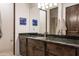 Bathroom featuring granite countertops, dark wood cabinetry, and large mirror at 9216 E Sky Line Dr, Scottsdale, AZ 85262