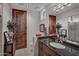 Bathroom with a dark granite countertop, modern fixtures, and unique decorative elements at 9216 E Sky Line Dr, Scottsdale, AZ 85262