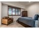 This bedroom features a comfortable armchair, window shutters, and stylish furnishings at 9216 E Sky Line Dr, Scottsdale, AZ 85262