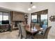Elegant dining room featuring a stone fireplace, tiled floors and a sliding glass door to the outdoor patio at 9216 E Sky Line Dr, Scottsdale, AZ 85262