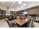 Open-concept kitchen and dining area with stone fireplace and wood cabinetry providing ample storage space at 9216 E Sky Line Dr, Scottsdale, AZ 85262