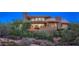 Modern home exterior with desert landscape and an inviting outdoor patio area at 9216 E Sky Line Dr, Scottsdale, AZ 85262