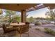 Charming covered patio with a round table and chairs, perfect for enjoying the outdoor scenery at 9216 E Sky Line Dr, Scottsdale, AZ 85262