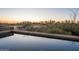 Infinity pool with desert landscape, creating a serene and scenic backyard view at 9216 E Sky Line Dr, Scottsdale, AZ 85262