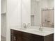 Double vanity bathroom with a large mirror and walk-in shower at 16014 W Cottontail Ln, Surprise, AZ 85387
