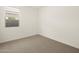 Bright bedroom with carpeted floor and window at 16014 W Cottontail Ln, Surprise, AZ 85387