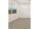 Bright bedroom with wood-look floors and window blinds at 16014 W Cottontail Ln, Surprise, AZ 85387