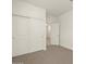 Bedroom with double door closet and access to hallway at 16014 W Cottontail Ln, Surprise, AZ 85387
