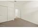 Bedroom with double door closet and access to hallway at 16014 W Cottontail Ln, Surprise, AZ 85387