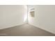 Well-lit bedroom featuring carpeted floor at 16014 W Cottontail Ln, Surprise, AZ 85387