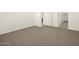Carpeted bedroom with access to bathroom and closet at 16014 W Cottontail Ln, Surprise, AZ 85387