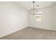 Bright dining room with large globe chandelier at 16014 W Cottontail Ln, Surprise, AZ 85387