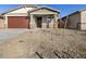 Single-story house with a brown garage door and rock accents at 16014 W Cottontail Ln, Surprise, AZ 85387