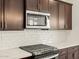 Close up of kitchen features, including gas range and microwave at 16014 W Cottontail Ln, Surprise, AZ 85387