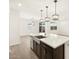 Modern kitchen island with farmhouse sink and pendant lighting at 16014 W Cottontail Ln, Surprise, AZ 85387