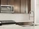 Modern kitchen features with stainless steel appliances and white subway tile at 16014 W Cottontail Ln, Surprise, AZ 85387
