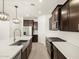 Open concept kitchen with island, stainless steel appliances, and light wood floors at 16014 W Cottontail Ln, Surprise, AZ 85387