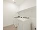 Laundry room with washer, dryer, and shelving at 16014 W Cottontail Ln, Surprise, AZ 85387
