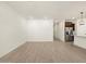 Bright living room with wood-look flooring and kitchen view at 16014 W Cottontail Ln, Surprise, AZ 85387