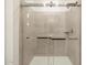 Large walk-in shower with glass enclosure and neutral tile at 16014 W Cottontail Ln, Surprise, AZ 85387