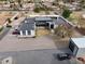 Aerial view of a modern home, featuring a metal roof, gravel landscaping, and ample parking at 23325 S 132Nd St, Chandler, AZ 85249