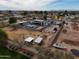 Wide aerial view of a property featuring a modern home, pool, outbuildings, and spacious land at 23325 S 132Nd St, Chandler, AZ 85249