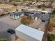 Aerial view of a modern home with a pool, surrounded by gravel landscaping and outbuildings at 23325 S 132Nd St, Chandler, AZ 85249