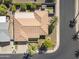 An aerial view of a single-Gathering home showcases a tile roof, manicured backyard with a hot tub, and lush landscaping at 4019 E Calypso Ave, Mesa, AZ 85206