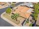 Well landscaped home with manicured lawn, mature palm trees, privacy walls, and a tile roof at 4019 E Calypso Ave, Mesa, AZ 85206