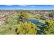 Scenic aerial view of the golf course in a residential community with lakes and lush greenery on a sunny day at 4019 E Calypso Ave, Mesa, AZ 85206
