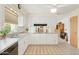 Bright kitchen with white cabinets, tile floors, stainless steel sink and appliances, and large window with natural light at 4019 E Calypso Ave, Mesa, AZ 85206