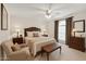 Elegant main bedroom with a comfortable queen bed, stylish furniture, and a serene ambiance with natural light at 4019 E Calypso Ave, Mesa, AZ 85206