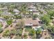 An aerial view displays the pool and grassy backyard of a home surrounded by mature trees at 4222 E Brown Rd # 31, Mesa, AZ 85205
