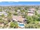 An aerial view showing a home with a pool, lush landscaping, and mountain views in the distance at 4222 E Brown Rd # 31, Mesa, AZ 85205
