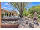 Large backyard with garden beds, gravel ground cover, an outdoor fireplace, and covered patio at 4222 E Brown Rd # 31, Mesa, AZ 85205