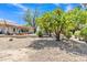Wide backyard showcasing mature trees and bushes with gravel ground cover at 4222 E Brown Rd # 31, Mesa, AZ 85205