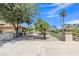 Home featuring a long driveway leading to the garage, with beautifully landscaped front yard at 4222 E Brown Rd # 31, Mesa, AZ 85205