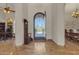 Spacious foyer with tile flooring, high ceilings, decorative doorway, and views to the lush exterior at 4222 E Brown Rd # 31, Mesa, AZ 85205