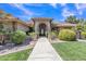 Beautiful single-story home with lush landscaping, green grass and inviting entryway at 4222 E Brown Rd # 31, Mesa, AZ 85205