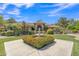 Elegant home featuring a manicured front yard with lush landscaping, a fountain, and a welcoming walkway under a bright sky at 4222 E Brown Rd # 31, Mesa, AZ 85205