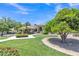 Well-maintained home featuring a lush front lawn with mature trees, flowering shrubs, and decorative fountain at 4222 E Brown Rd # 31, Mesa, AZ 85205