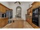 Kitchen with granite countertops, travertine floors, stainless steel appliances, and a center island at 4222 E Brown Rd # 31, Mesa, AZ 85205
