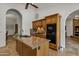 The kitchen features travertine floors, granite countertops, and wooden cabinetry at 4222 E Brown Rd # 31, Mesa, AZ 85205