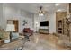 Comfortable living room features tall ceilings, brick fireplace, ceiling fan, and tile flooring at 4222 E Brown Rd # 31, Mesa, AZ 85205