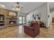Inviting living room featuring a fireplace, tile floors, and access to the backyard through French doors at 4222 E Brown Rd # 31, Mesa, AZ 85205