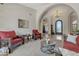 Open-concept living room showcasing arched doorways, marble floors, and rustic furniture at 4222 E Brown Rd # 31, Mesa, AZ 85205